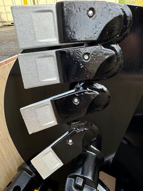 A close up of a black object with a few pieces of metal on it