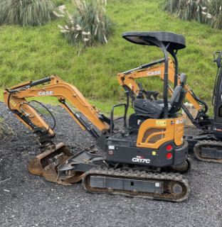 Two case excavators are parked next to each other