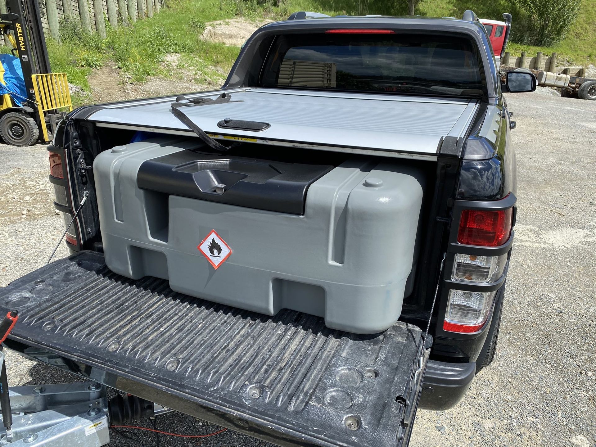 A truck with a large tank in the back of it.