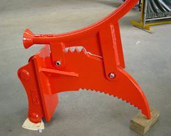 A red tool is sitting on top of a wooden block.