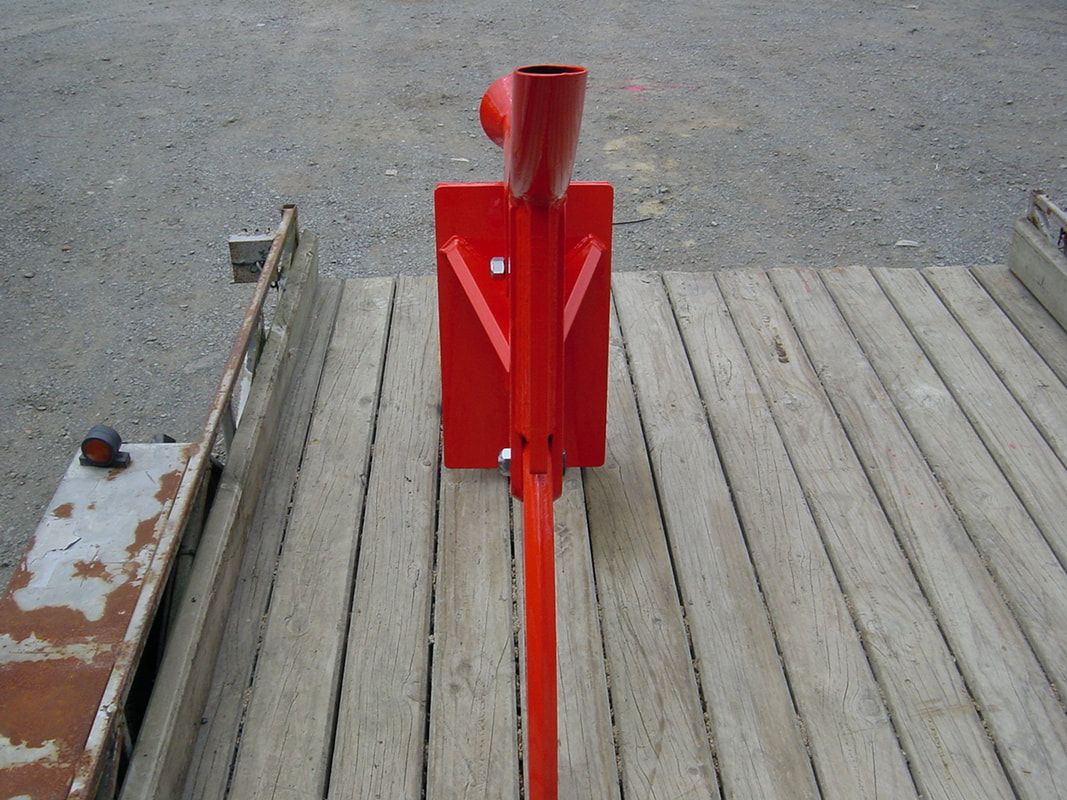 A red object is sitting on a wooden deck
