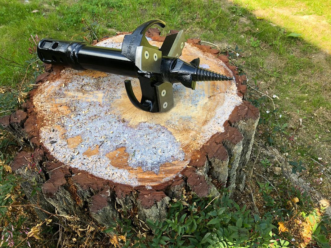 A machine is sitting on top of a tree stump.