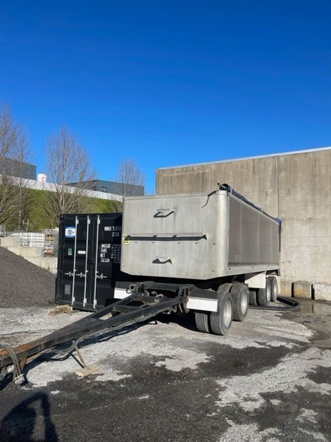 A dump truck is parked in front of a building