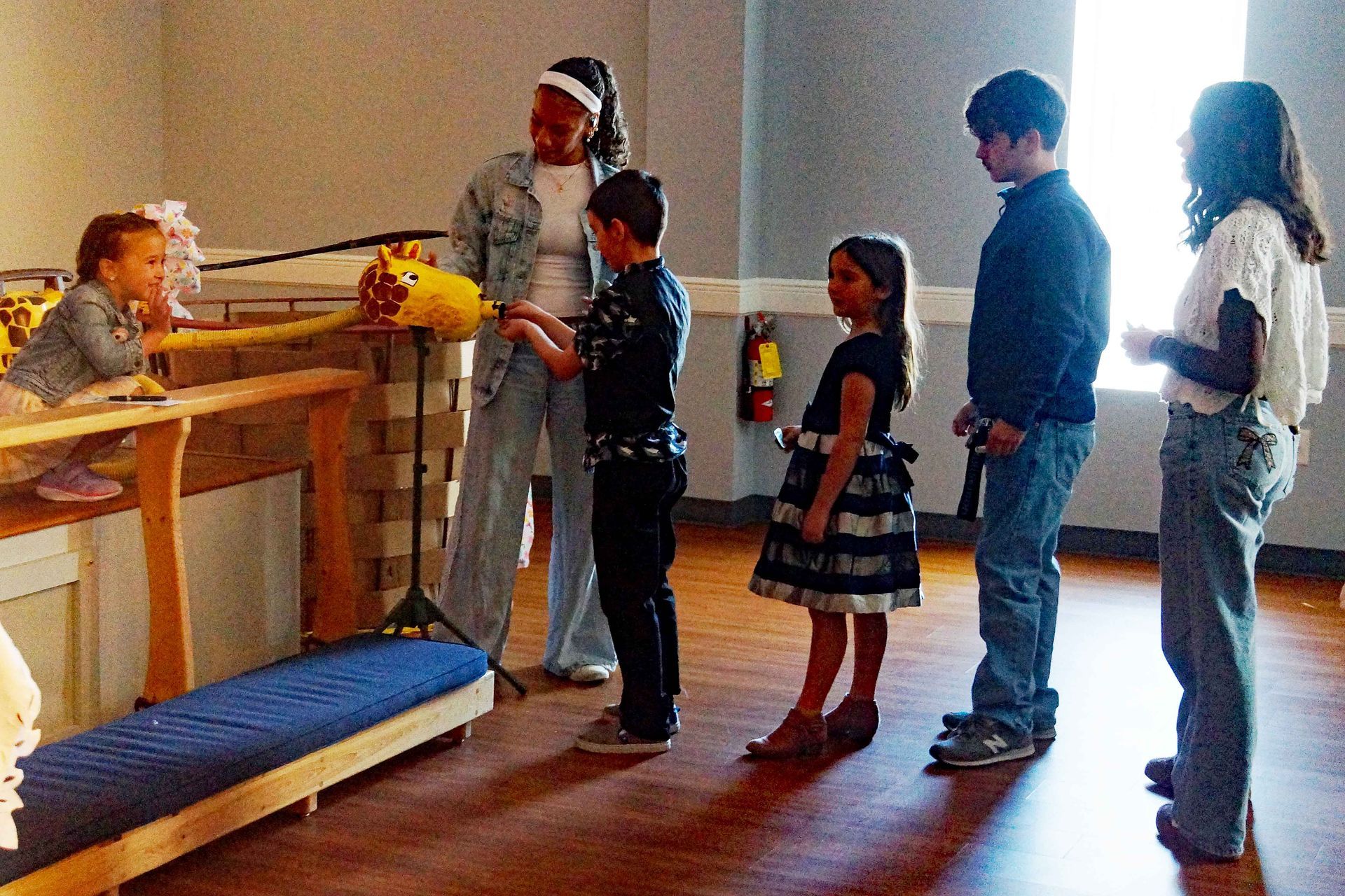 Children standing in line to give to their Gerald the Giraffe offering