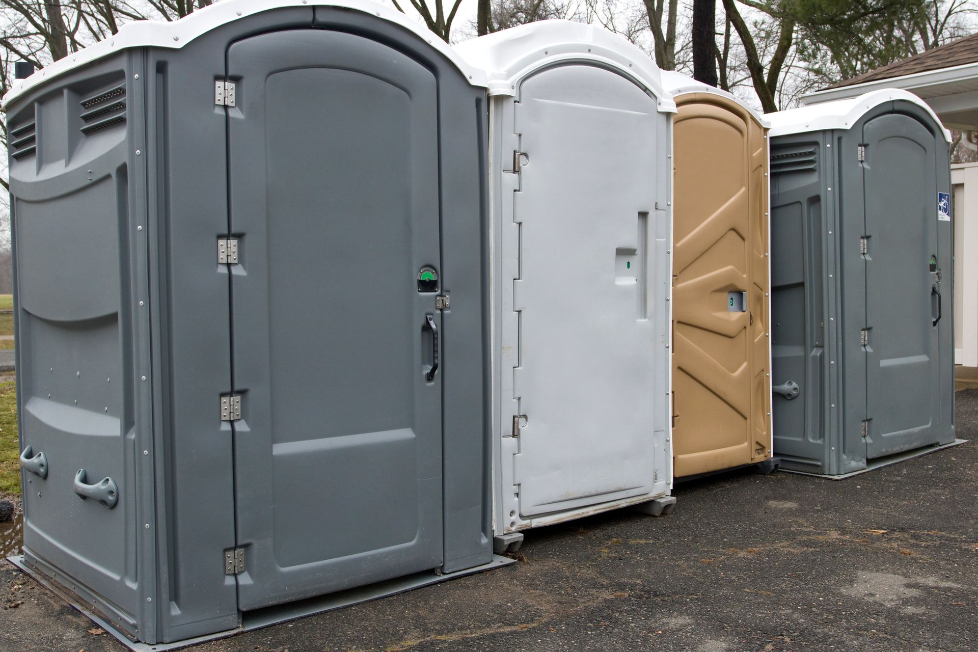 Portable Toilets in a row in a public Park Portable Toilets in a row in a public Park