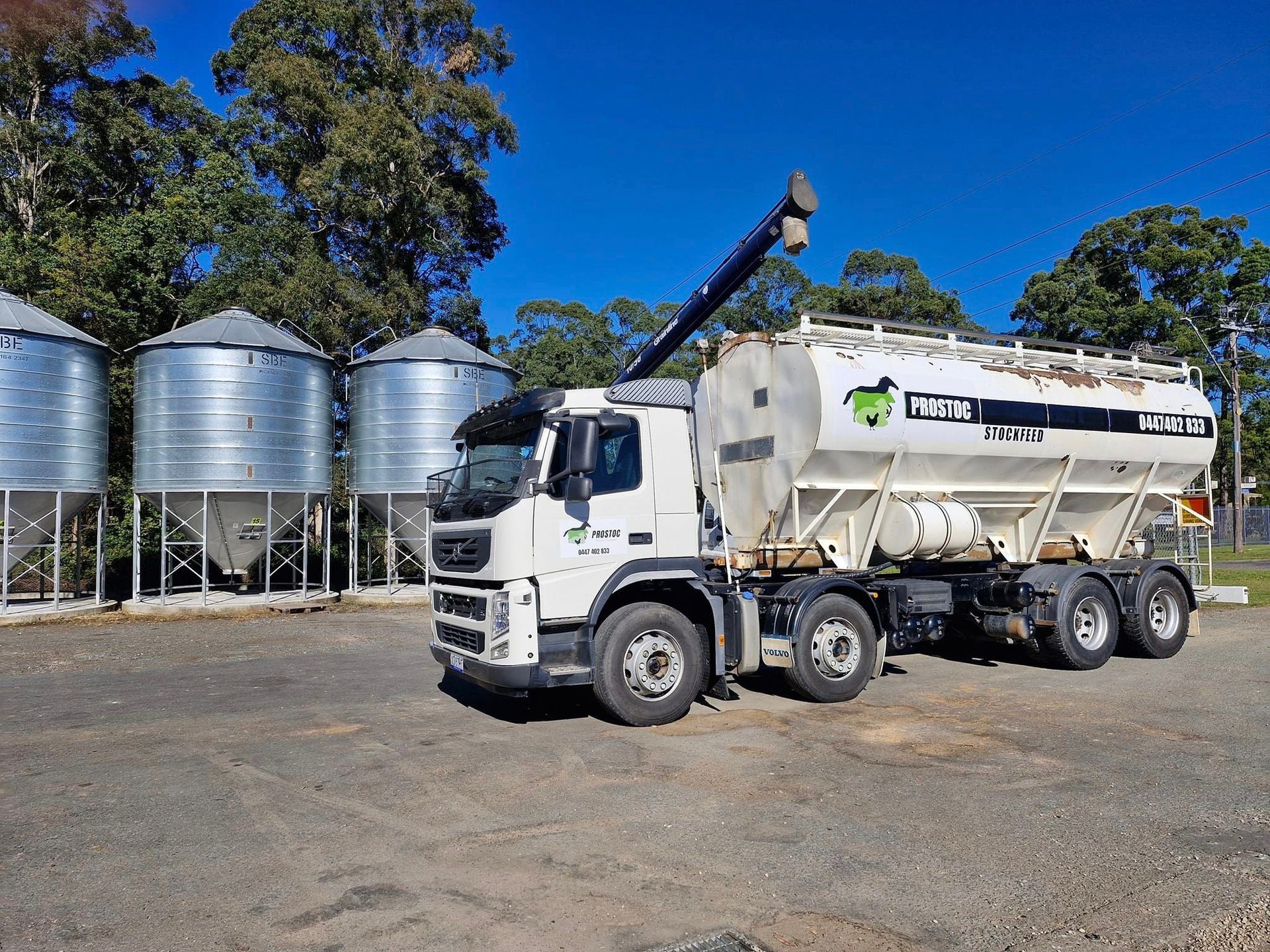 White Truck With Silo Tank, Parked Next to Metal Grain Silos — Prostoc In South Kempsey, NSW