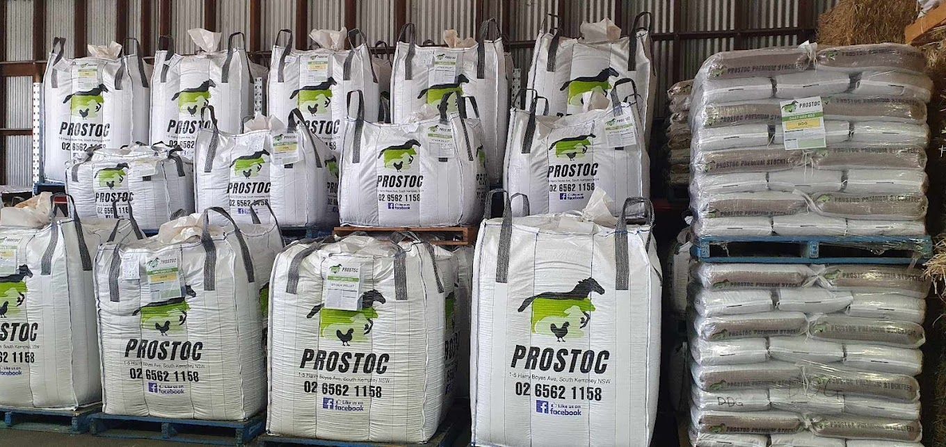 Large White Bags of Prostoc Feed Stacked on Pallets in a Warehouse — Prostoc In Bellingen, NSW