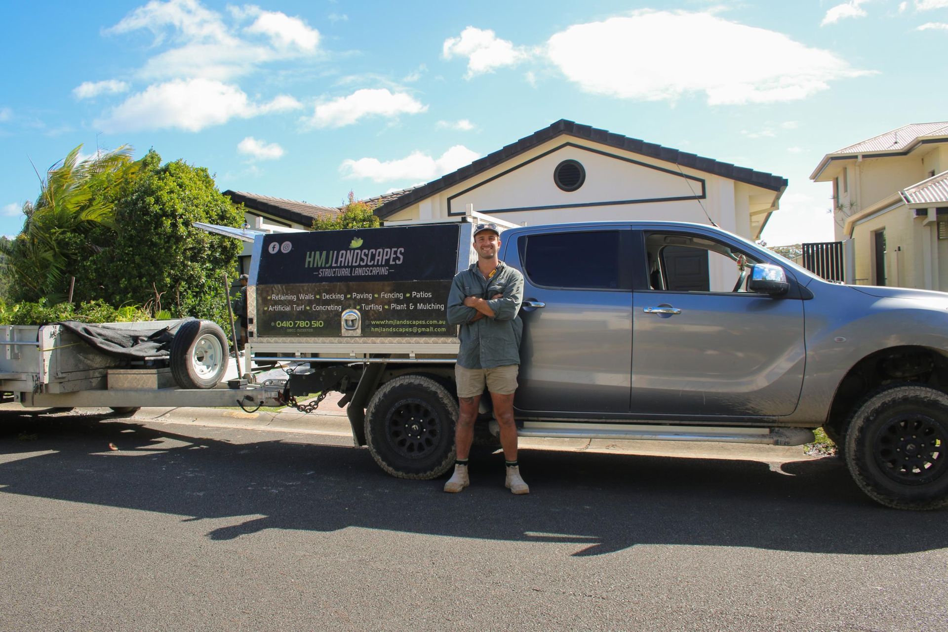 A Man Standing Next to a Truck That Says HM Landscapes — HMJ Landscapes in Broadbeach, QLD