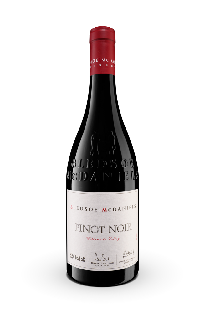 Bottle of Pinot Noir wine with a red cap and white label on a white background