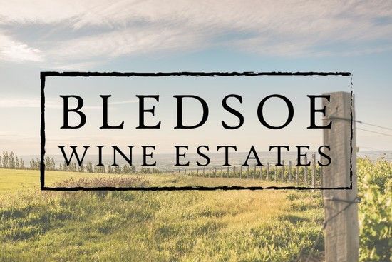 Bledsoe Wine Estates sign in a grassy field at sunset