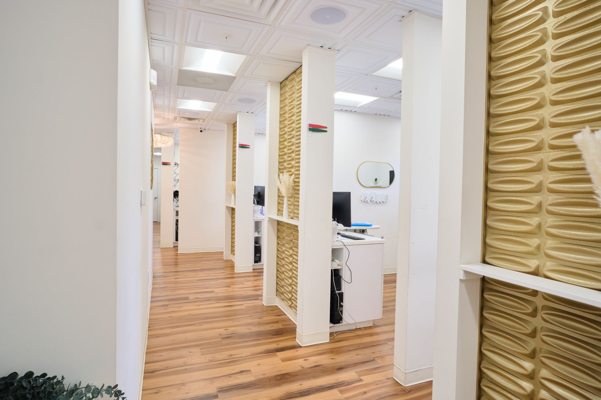 The Dental Boutique Westchase hallway in a dental office with wooden floors and white walls.