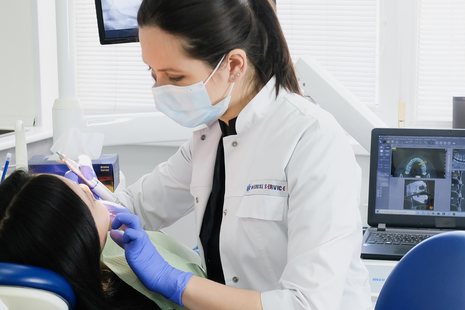 dentist in clinic providing treatment