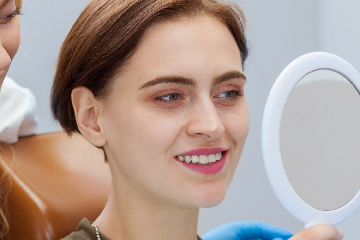women happy with her dental implant results