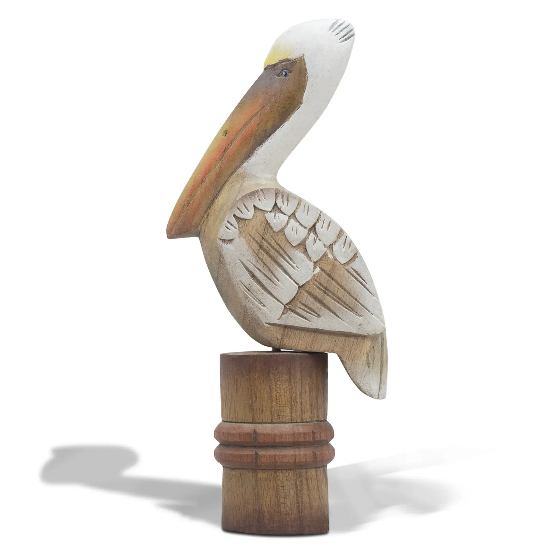 Wooden pelican figurine perched on a small cylindrical Piling base, with a white and tan painted body.