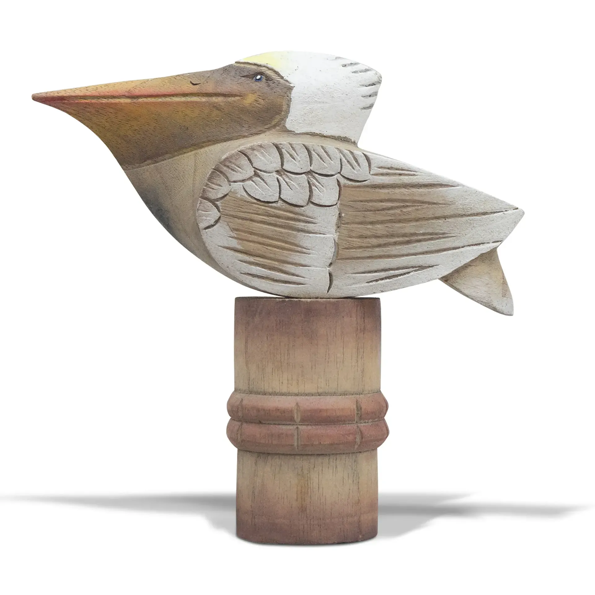 Carved wooden Pelican figurine with a long beak, white head, and tan body on a small pedestal
