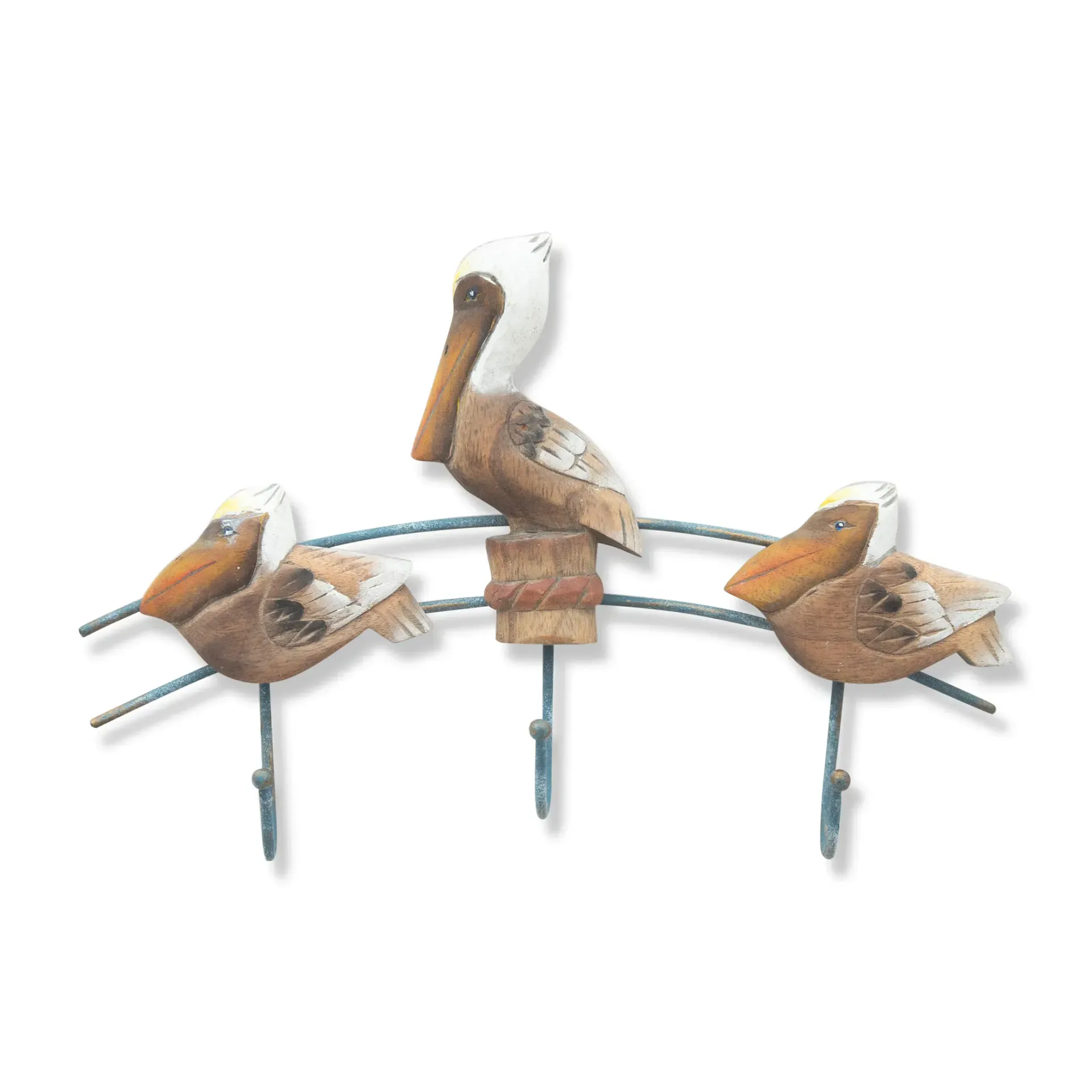 Three pelicans perched on a curved metal rail with three hooks, one centered above the other two