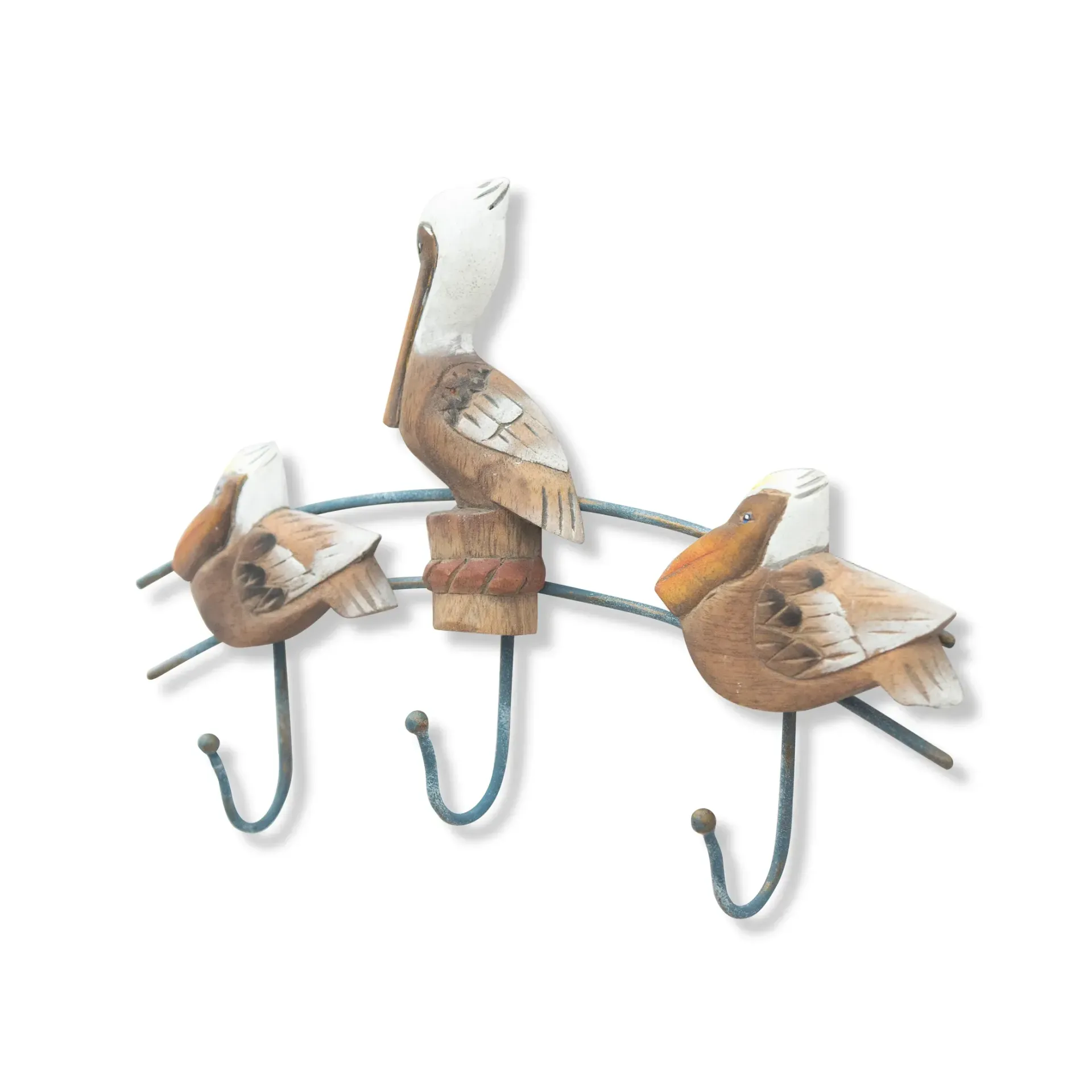 Three pelicans perched on a curved metal rail with three hooks, one centered above the other two