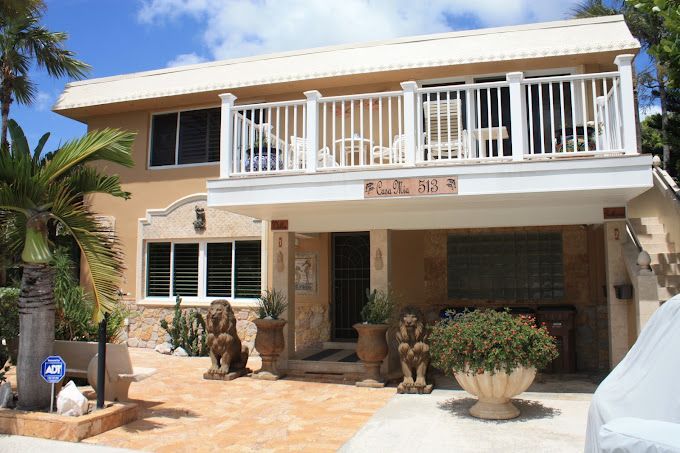 A house with a balcony and a sign that says ' a ' on it