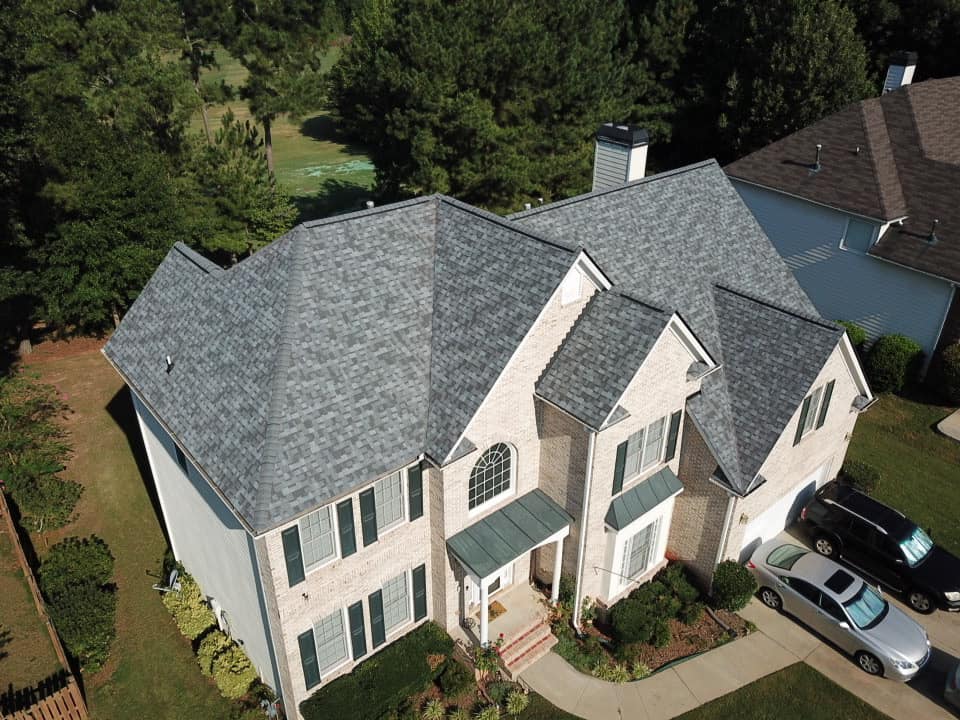Total Roof Solutions in McDonough, GA repaired grey roof on massive house