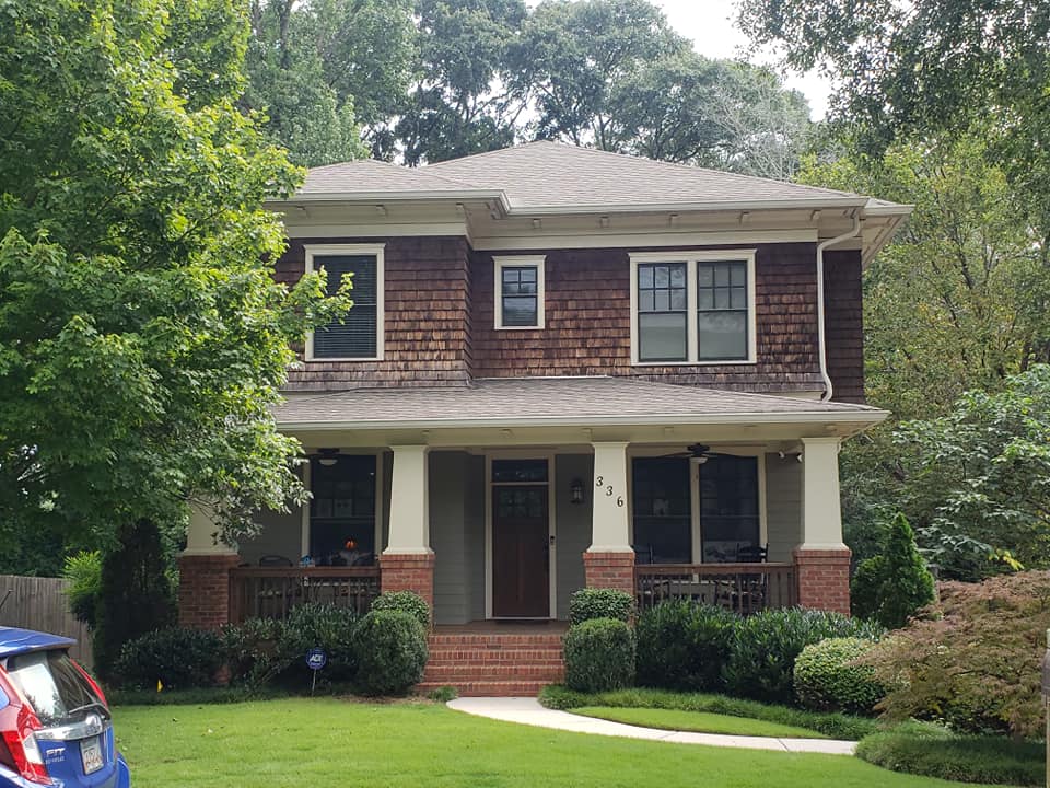 brick house with white roof repairs Total Roof Solutions