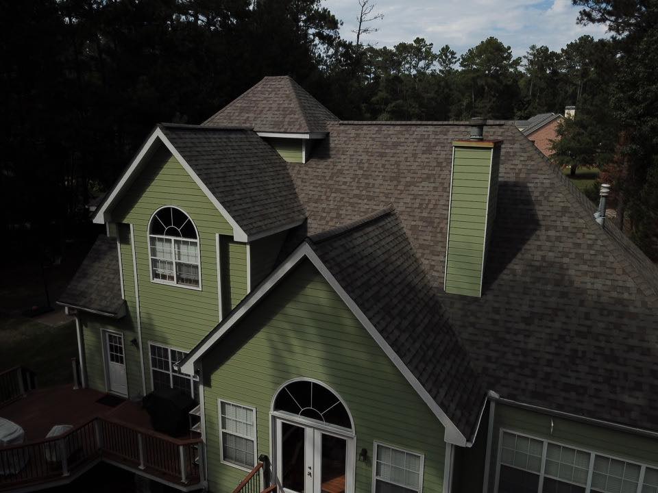 Total Roof Solutions roofing experts in McDonough, GA green house with brown roof