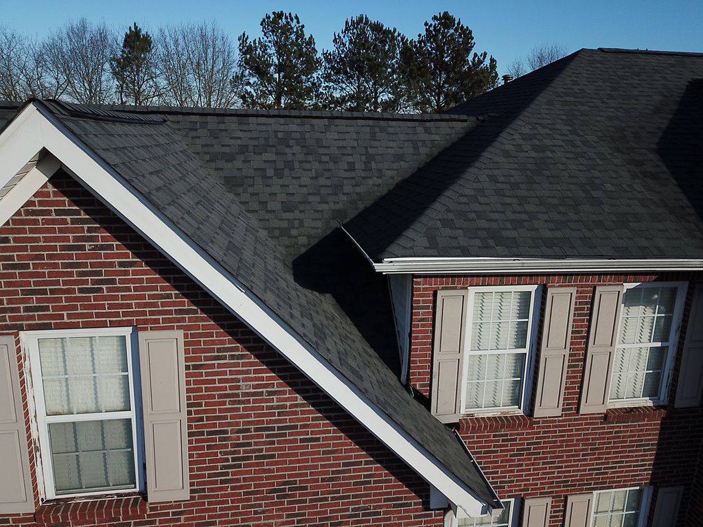 red brick house with dark grey roof tiles in McDonough, GA