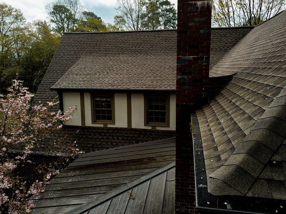 Brown roof and gutters worked on by Total Roof Solutions McDonough, GA