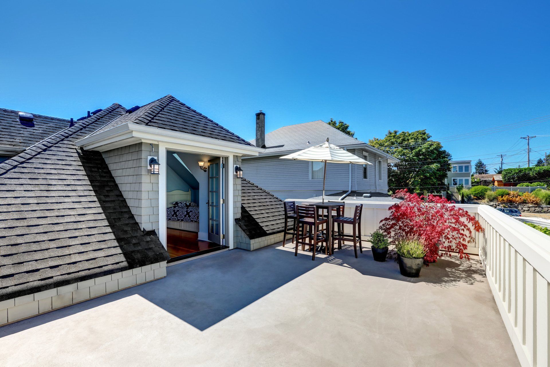 white and grey house with roof deck