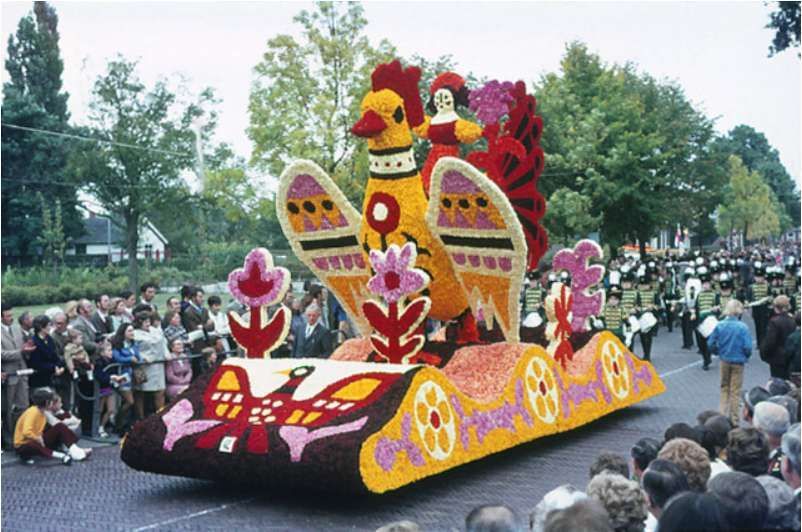 Een parade met een haan en bloemen op een praalwagen