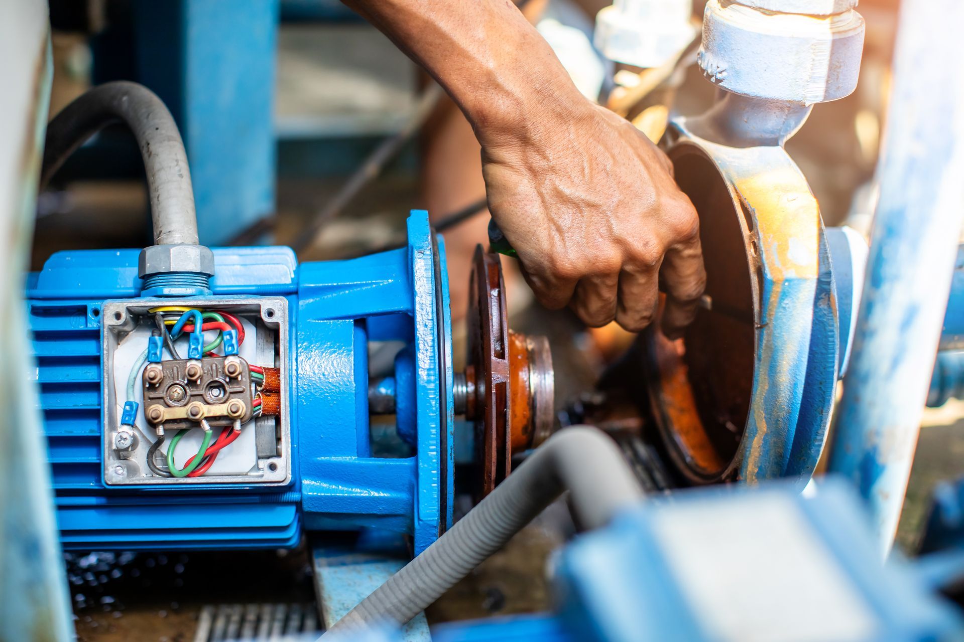 A man is repairing a water pump.