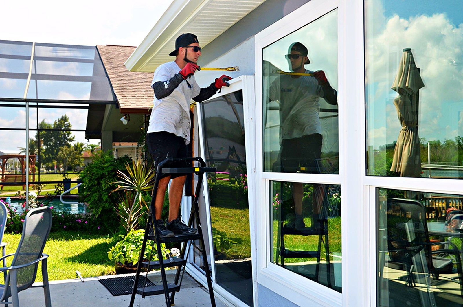 Hom-Excel in-house installer measuring a new impact door installation on a Florida home