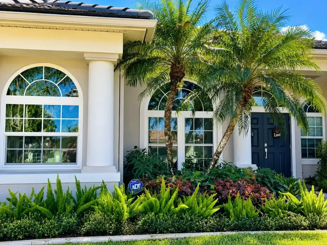 Impact-rated sliding glass doors opening to a waterfront view, installed by Hom-Excel
