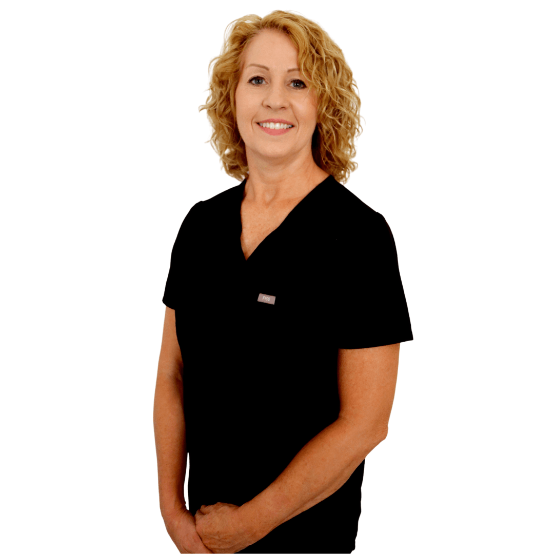 A smiling professional with shoulder-length blonde hair wearing a black V-neck scrub top against a white background.