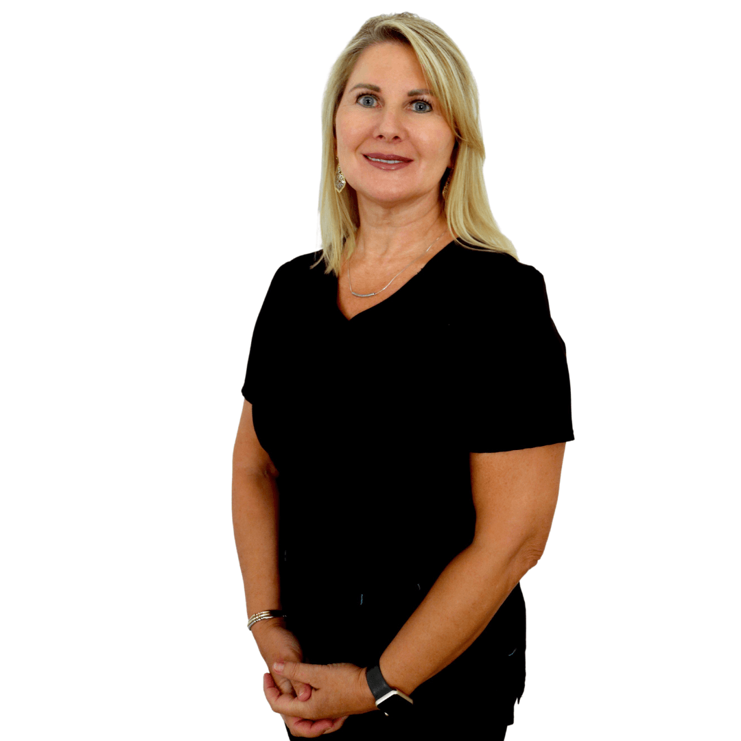 A smiling person with shoulder-length blonde hair wearing a black shirt, standing against a white background.