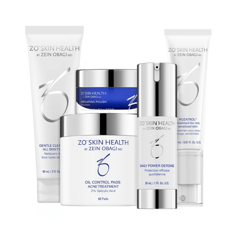 A collection of five white and blue ZO Skin Health skincare products, including tubes, a jar, and a pump dispenser.