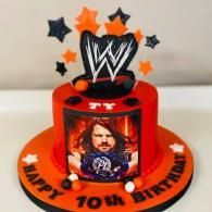 Red WWE-themed birthday cake with black stars and 