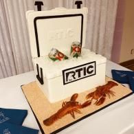 RTIC cooler cake with red crab decorations on a table at a party