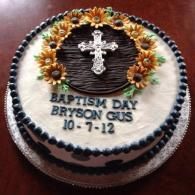 Baptism Day cake with cross, sunflowers, and the name Bryson Gus, dated 10-7-12