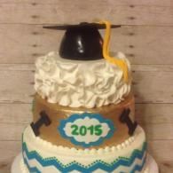 Three-tier graduation cake with black cap topper and 2015 plaque