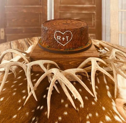 Rustic orange antler hat with a heart-shaped R+T monogram on a fur-covered surface