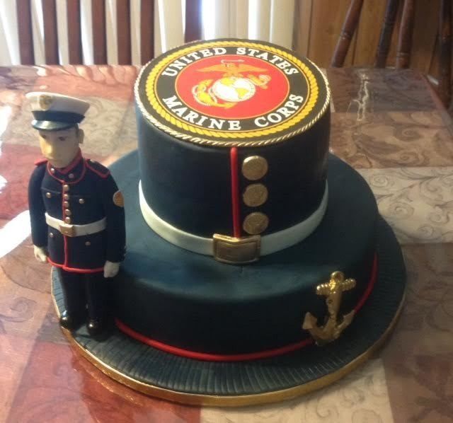Marine Corps dress uniform cake with a figurine and gold insignia on top