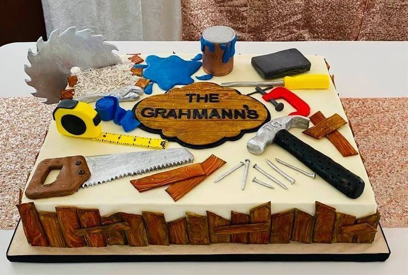 Birthday cake decorated like a saw and tools, with “The GRAMHANN’S” written on top.