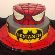 Spider-Man themed cake with red web design and a yellow Batman-style emblem reading “BENJAMIN”