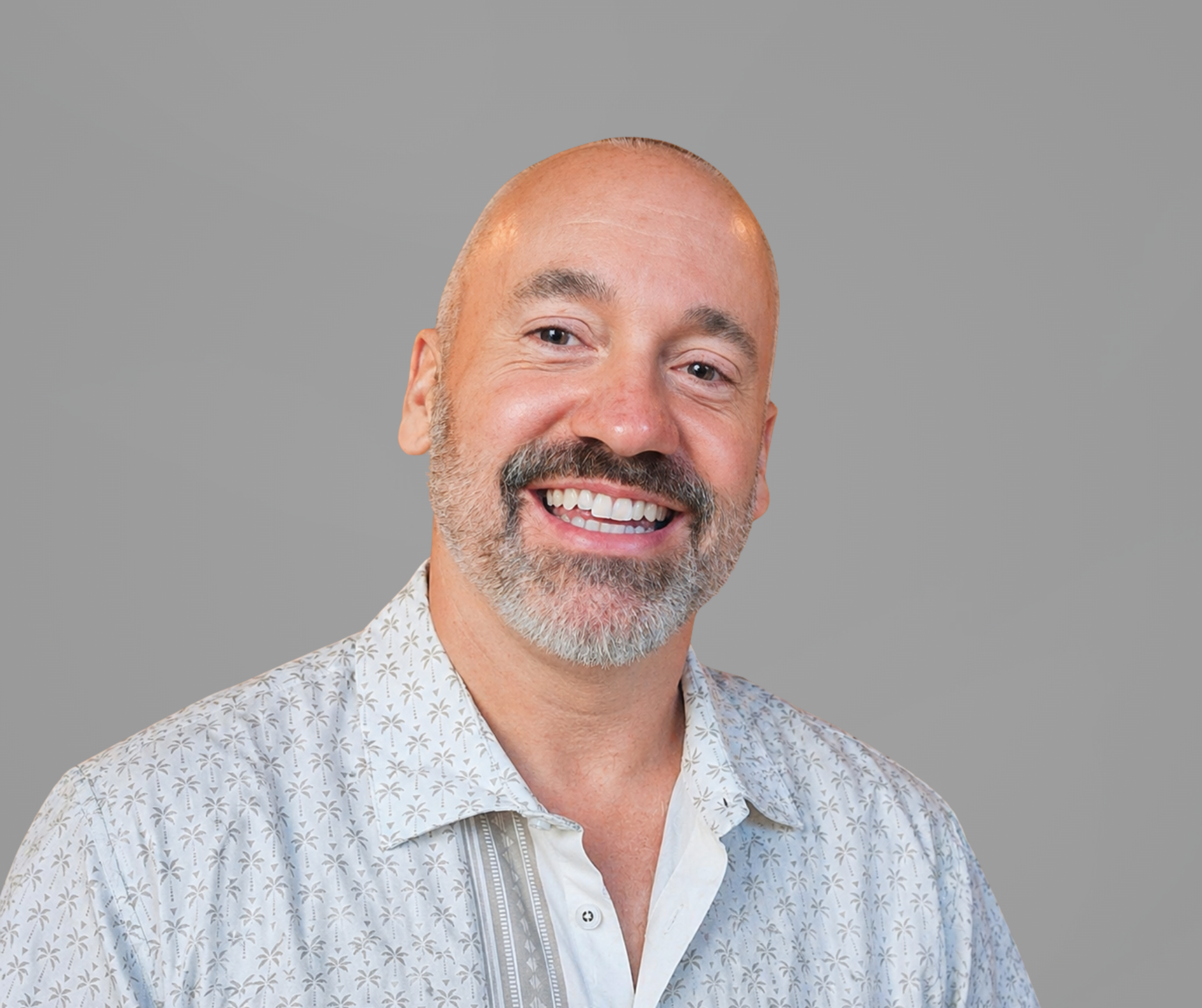 Portrait of a person in glasses wearing a dark sweater against a gray background