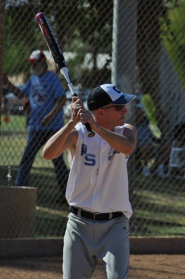 Baseball player in white uniform preparing to swing at bat on a field