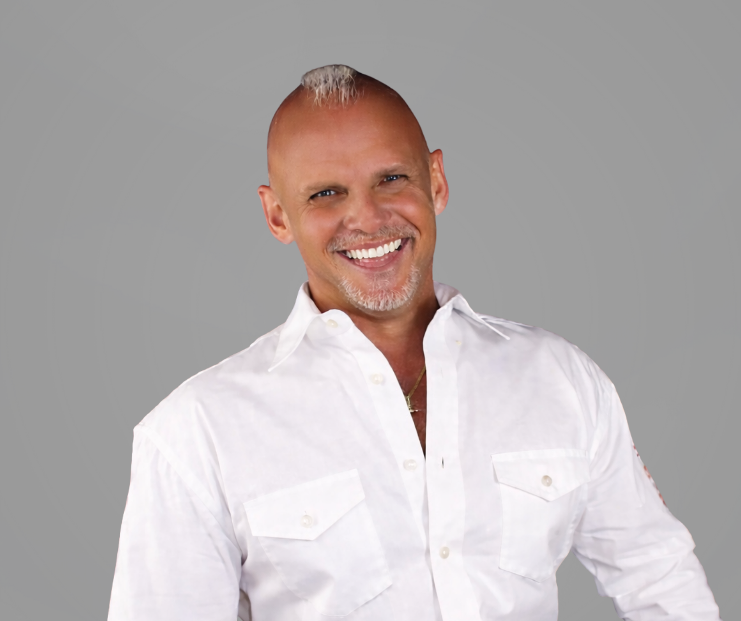 Headshot of Tommie Douglas, a man smiling with a goatee, wearing a white collared shirt, set upon a gray background.