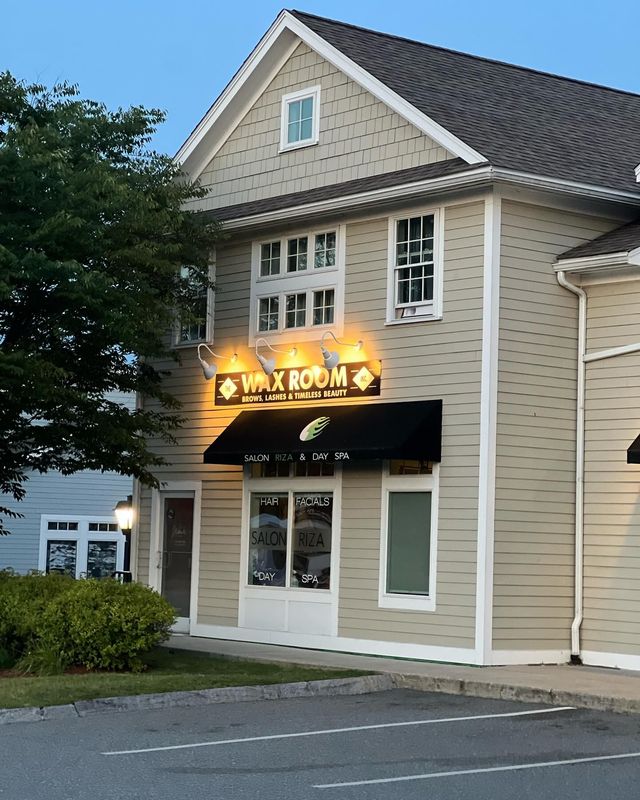 A building with a sign that says wax room on it