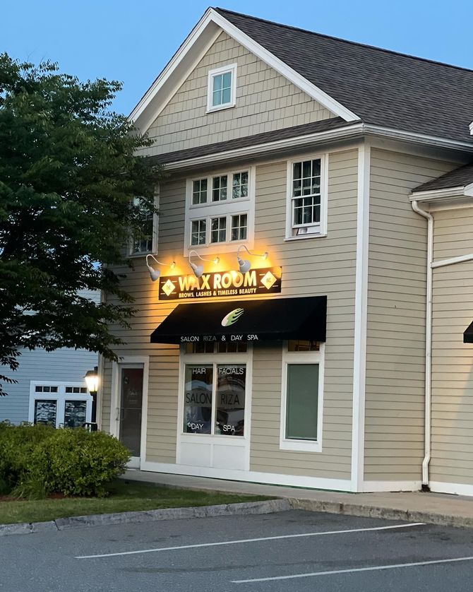 A building with a sign that says wax room on it