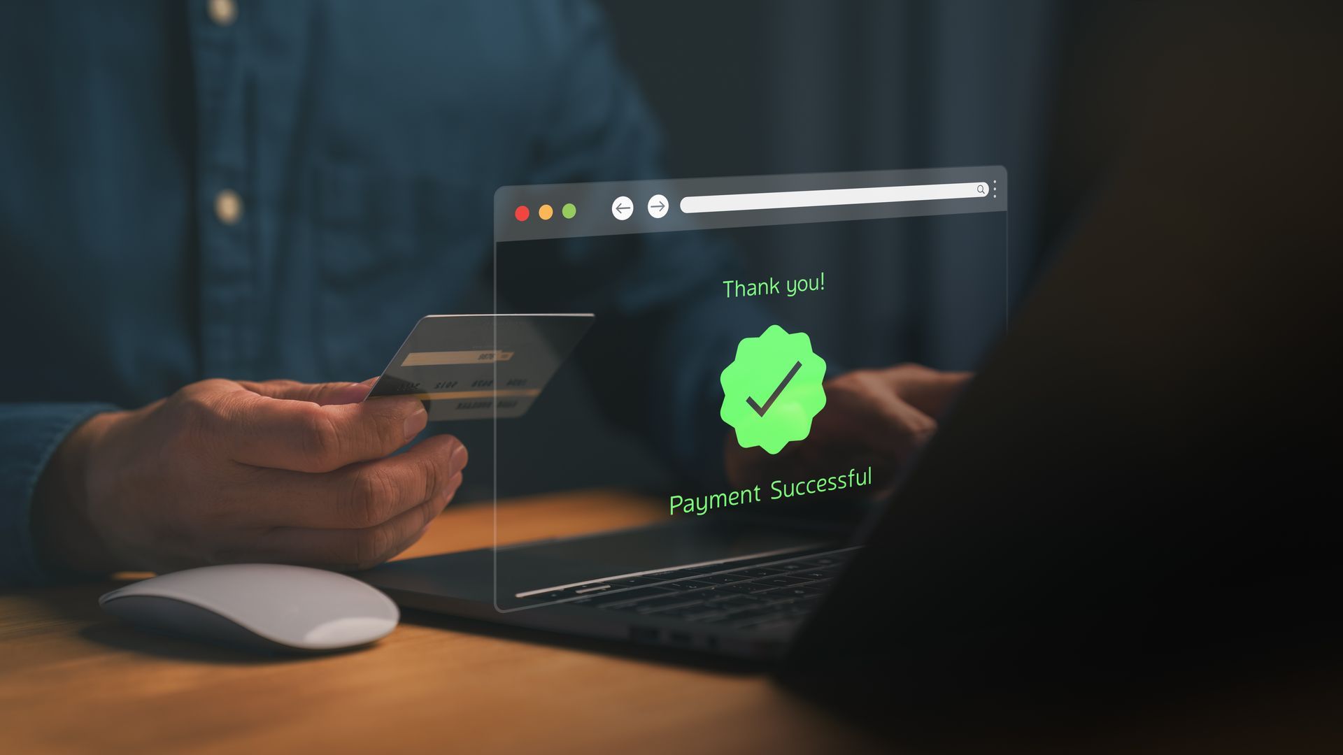 Person holding credit card near laptop, overlay displays Person holding credit card near laptop, overlay displays