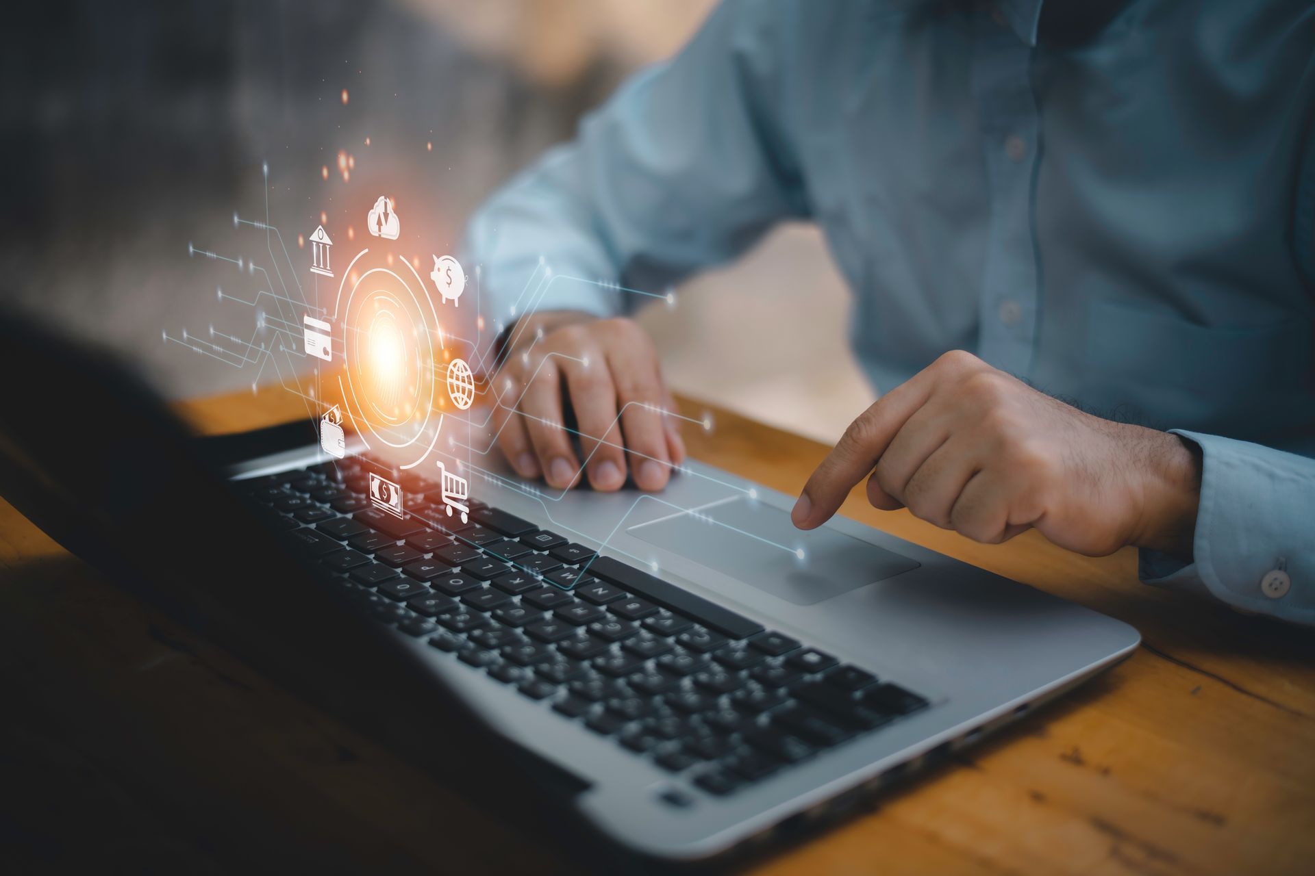 Person using laptop, digital icons hovering above the screen, indicating technology and data processing. Person using laptop, digital icons hovering above the screen, indicating technology and data processing.